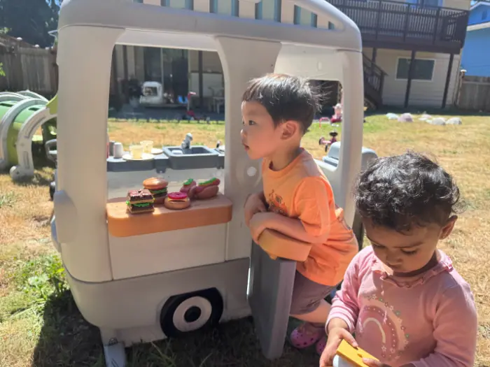 Toddler engaging in play-based learning with blocks at a Bothell child care center.