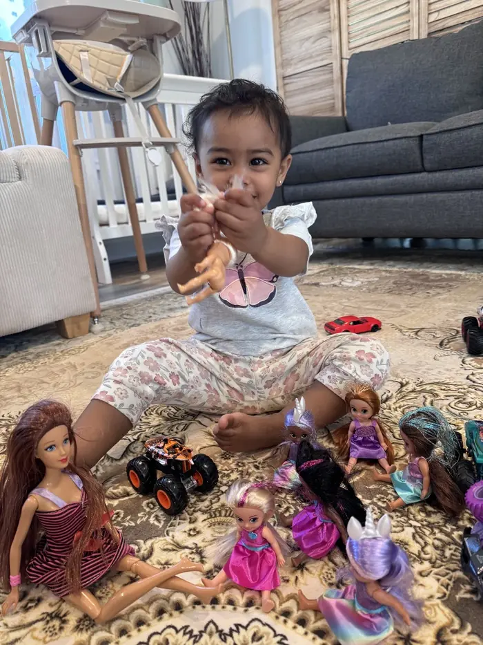 Toddler enjoying sensory play on their first day at daycare.