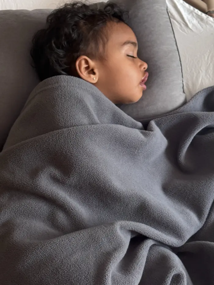 Peaceful sleeping toddler in daycare nap room – safe and cozy rest environment for infants and preschoolers