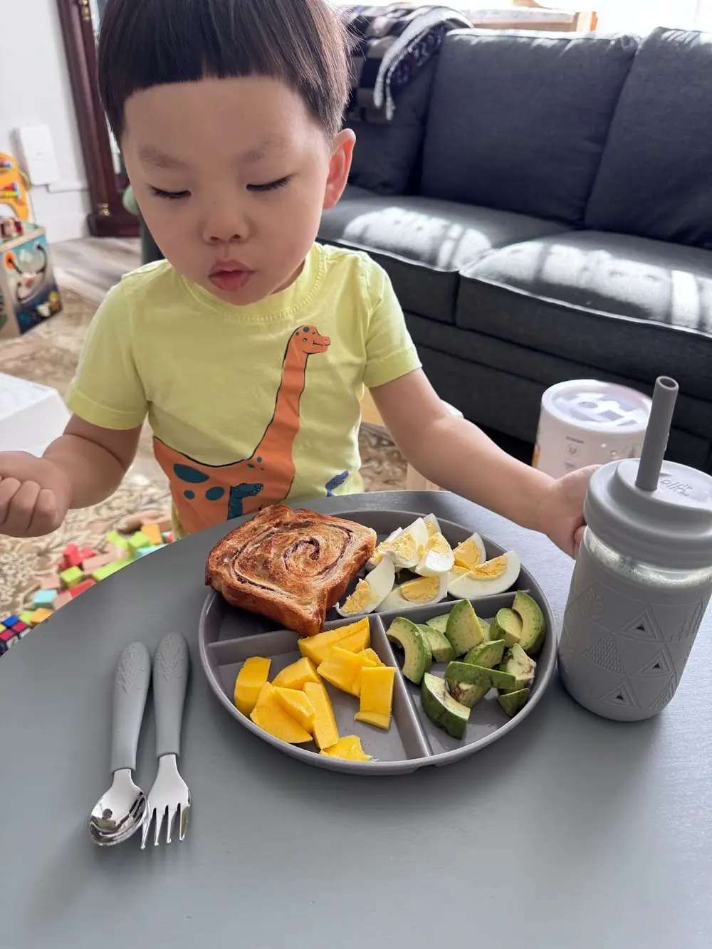 Preschoolers practicing independence by setting the table during mealtime at Kido Heaven Child Care in Bothell, WA.