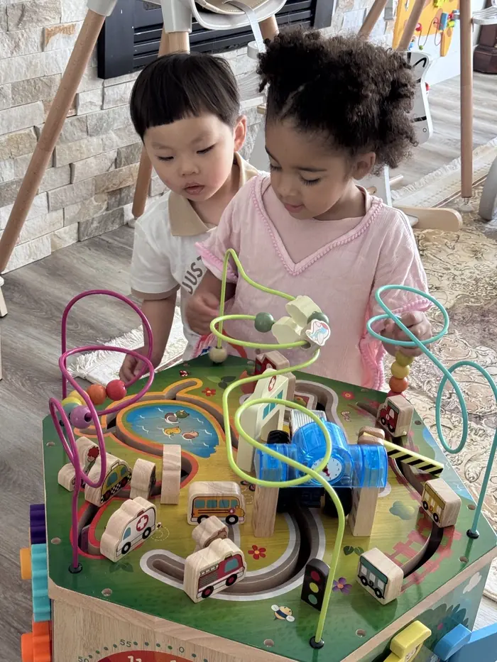 Cozy home day care environment with children playing quietly in a home-like setting, ideal for infant care.