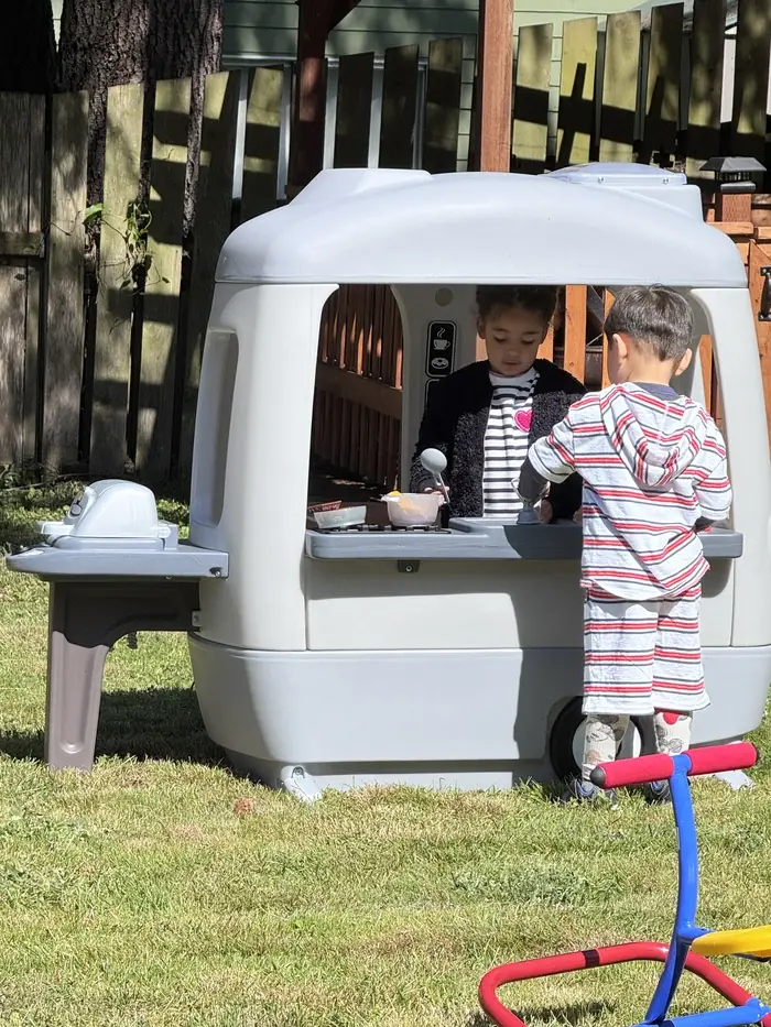 Children playing imaginative outdoor games at Kidoheaven daycare in Bothell