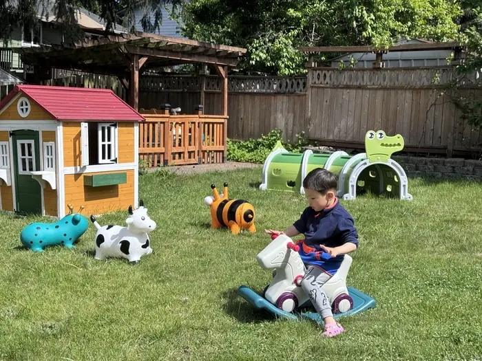  Happy children playing outdoors in a daycare, showcasing the importance of efficient scheduling for childcare administrators.  