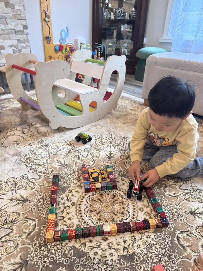 A daycare teacher engaging with children in a group activity to support developmental milestones.