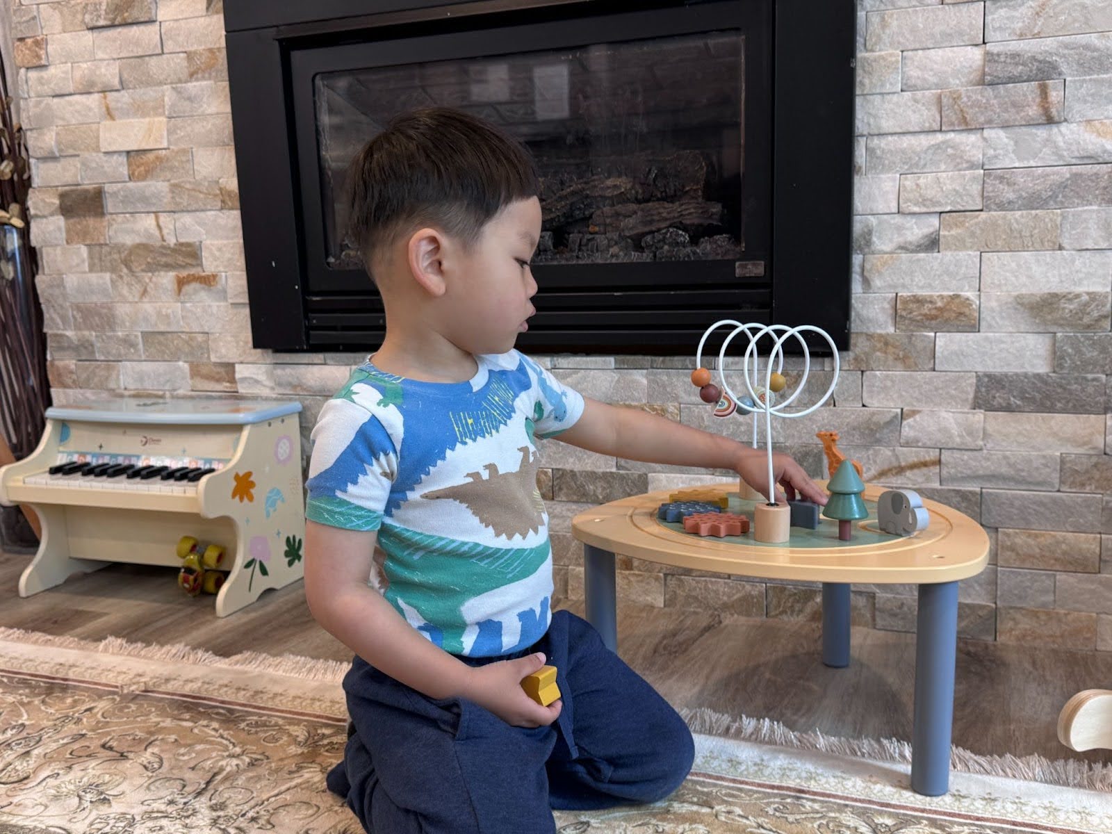Young child engaged in indoor Montessori-style play with educational toys in a home daycare setting.