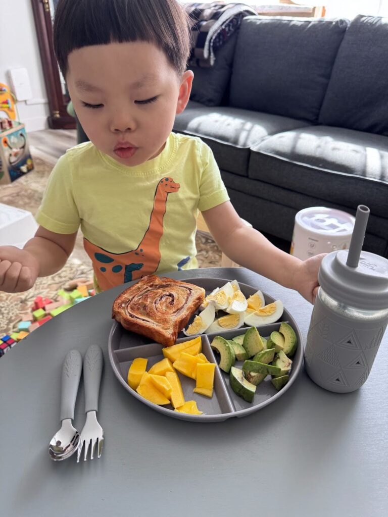 Preschoolers practicing independence by setting the table during mealtime at Kido Heaven Child Care in Bothell, WA.