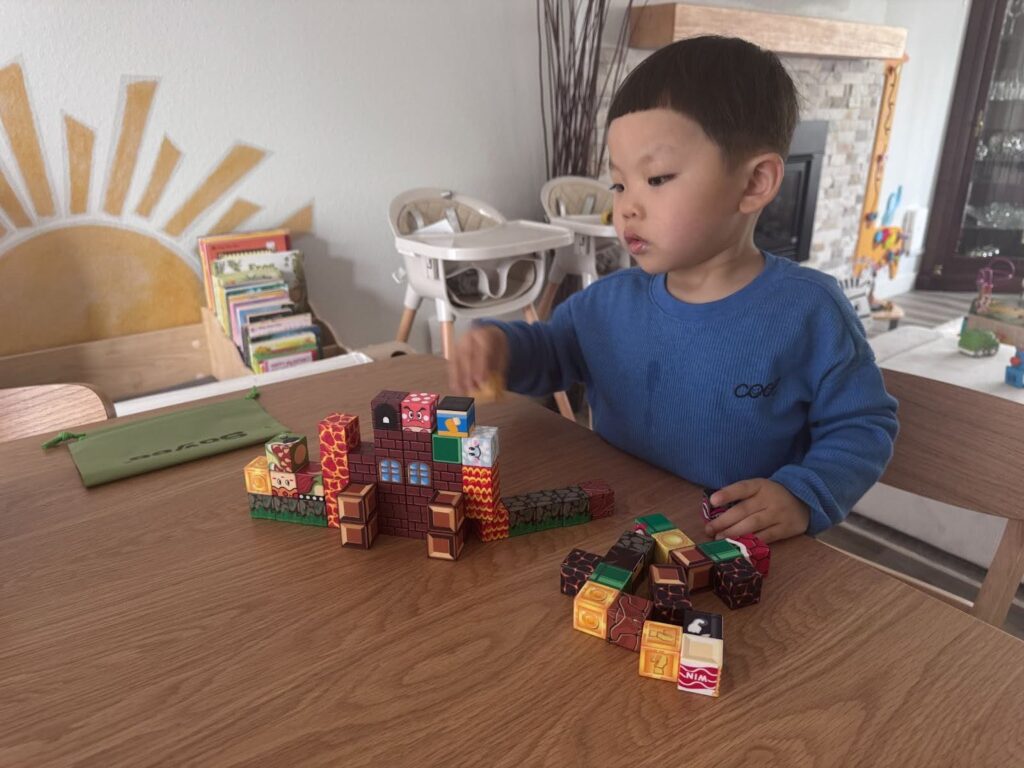 Preschool children building towers with wooden blocks at Kido Heaven Child Care in Bothell, WA