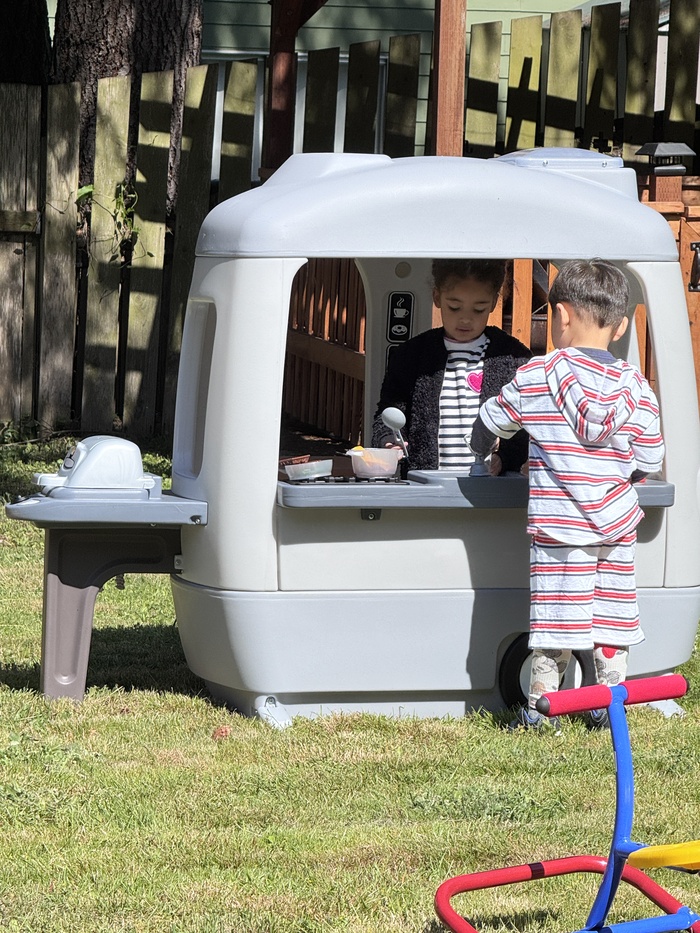 Children playing imaginative outdoor games at Kidoheaven daycare in Bothell