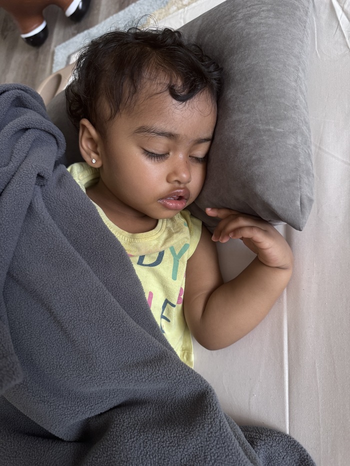 Infant sleeping peacefully in a safe crib at daycare