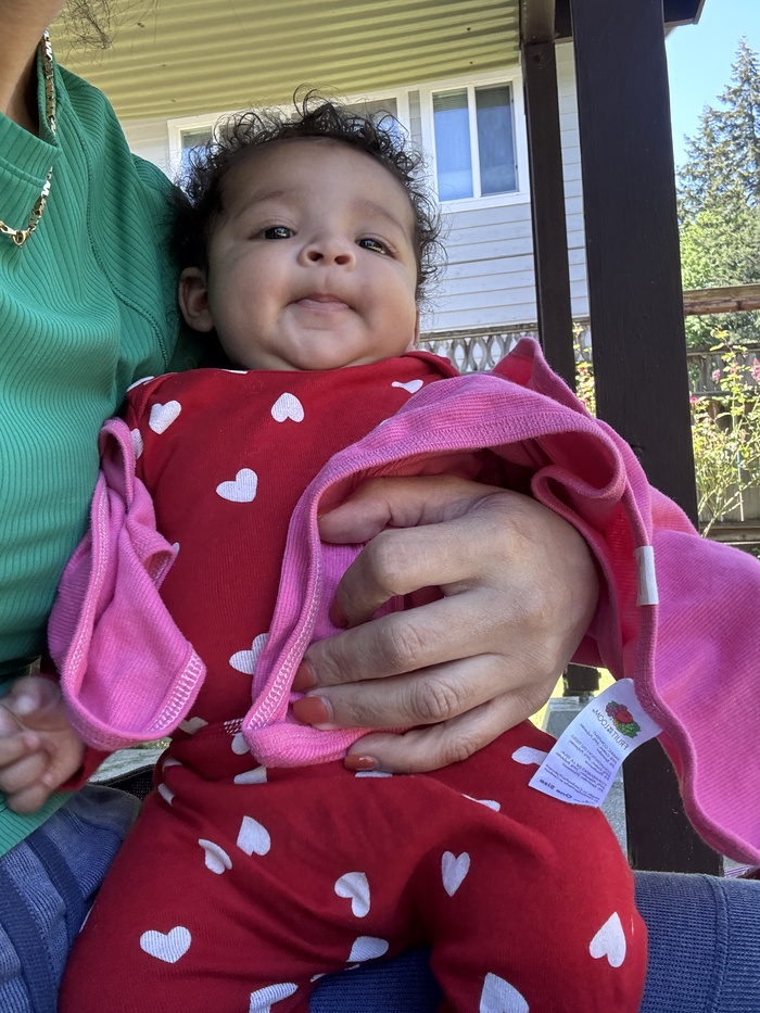 Caregiver in Bothell child care soothing infant with gentle rocking.  