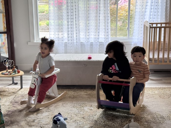 A diverse group of children in a daycare classroom engaging in a cultural art activity.  