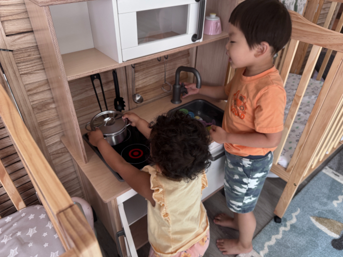 Childcare provider encouraging gender-neutral play with diverse toys