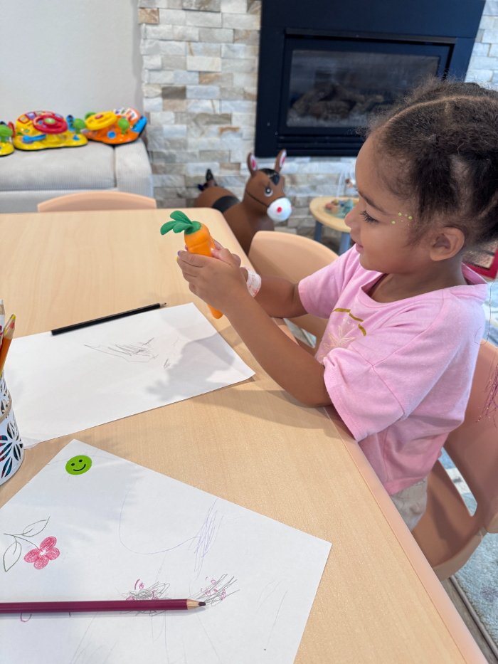 Preschooler encouraged with high-five for positive behavior  
