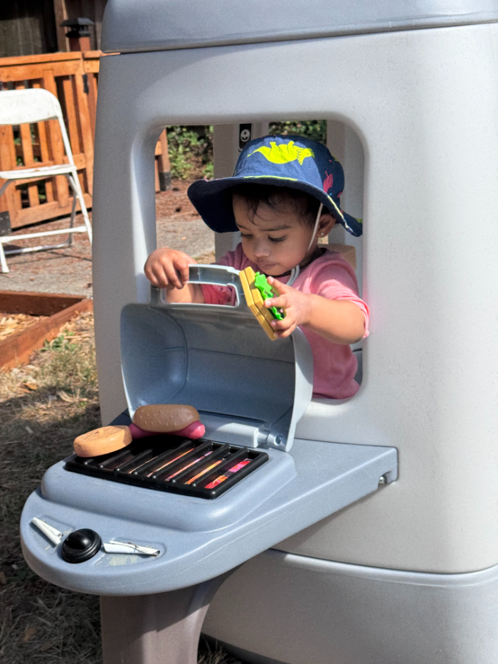 Outdoor free play at daycare – toddler swinging and sliding instead of tablet time