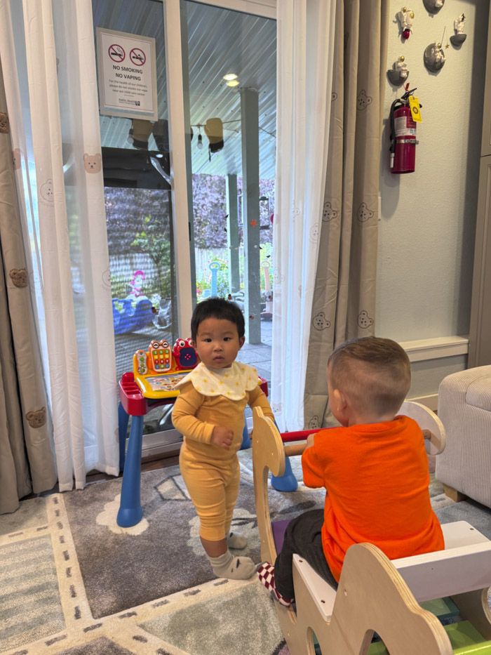 child engaging with household objects in daycare