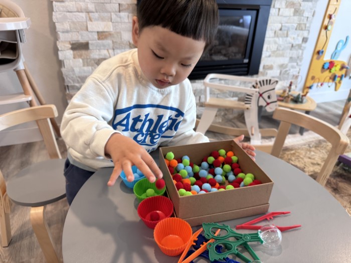 Toddler solving a simple puzzle in childcare