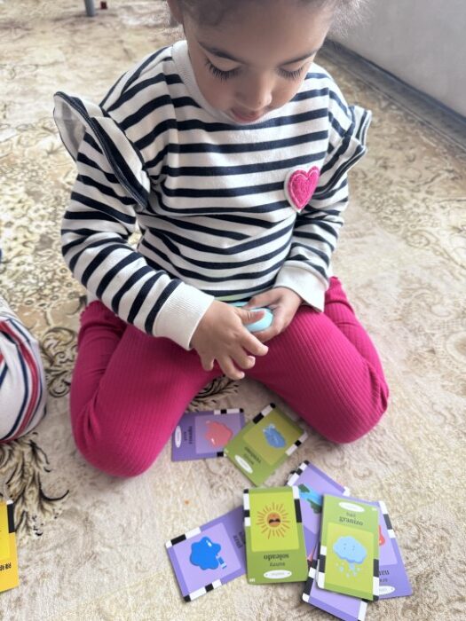 Preschool children working together on a challenge