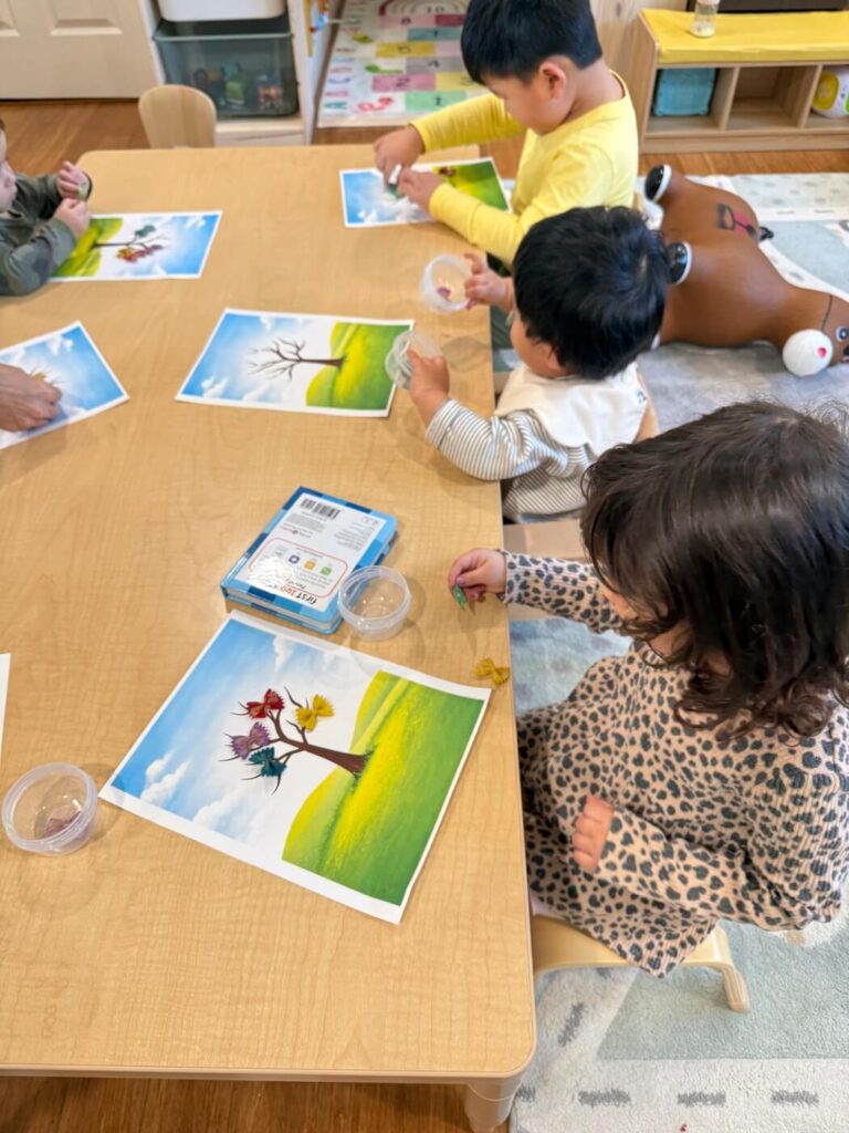 Children sharing toys in structured classroom environment
