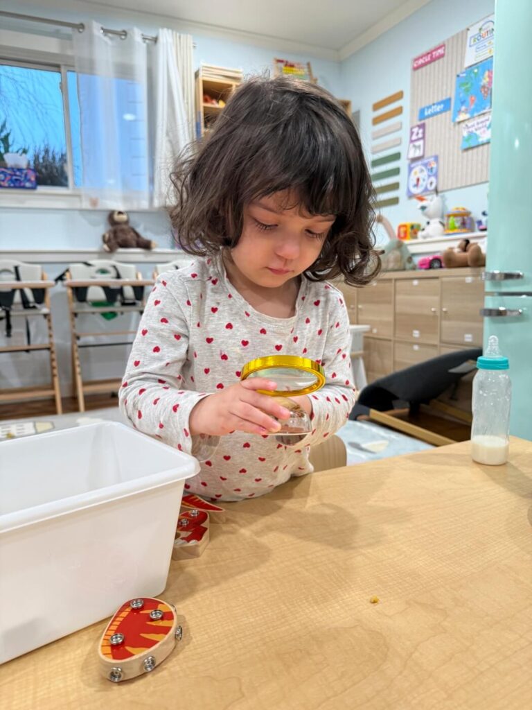 child choosing between toys in daycare
