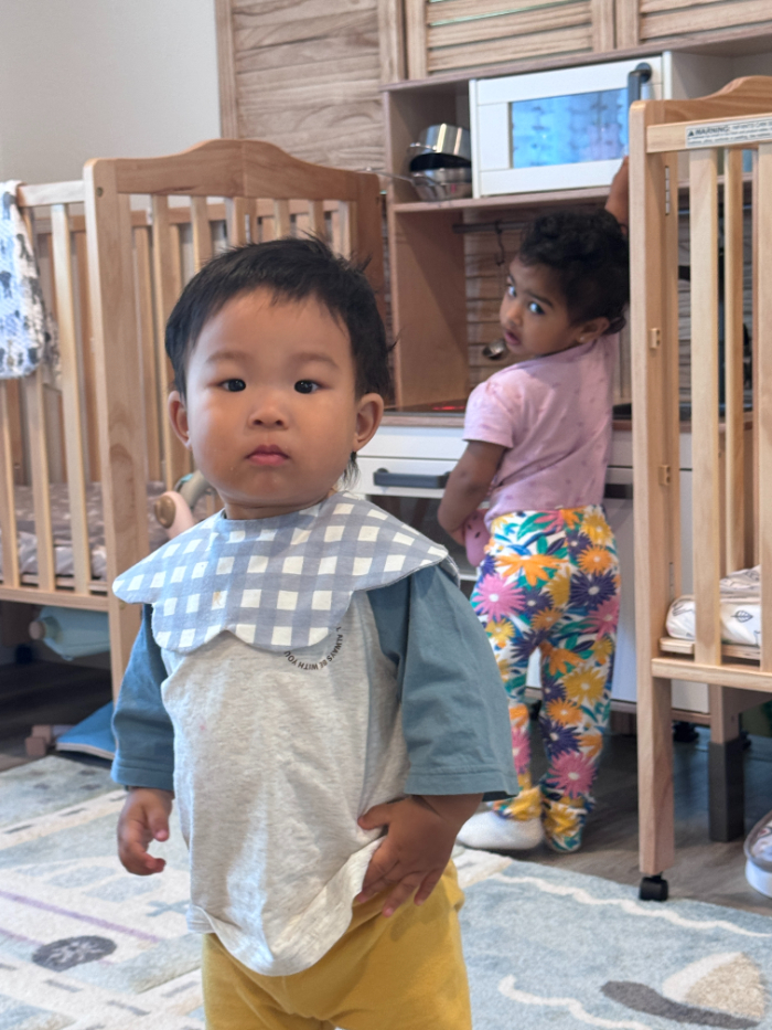 child playing comfortably in daycare classroom

